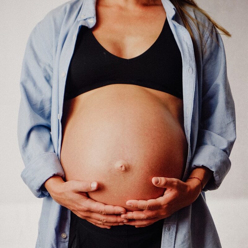 a pregnant woman holding her belly in her hands